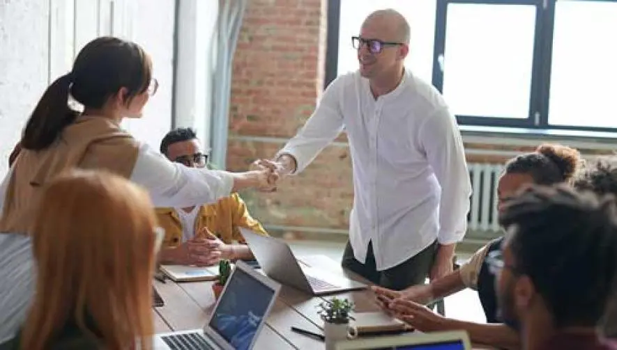 man shaking hands at a club meeting